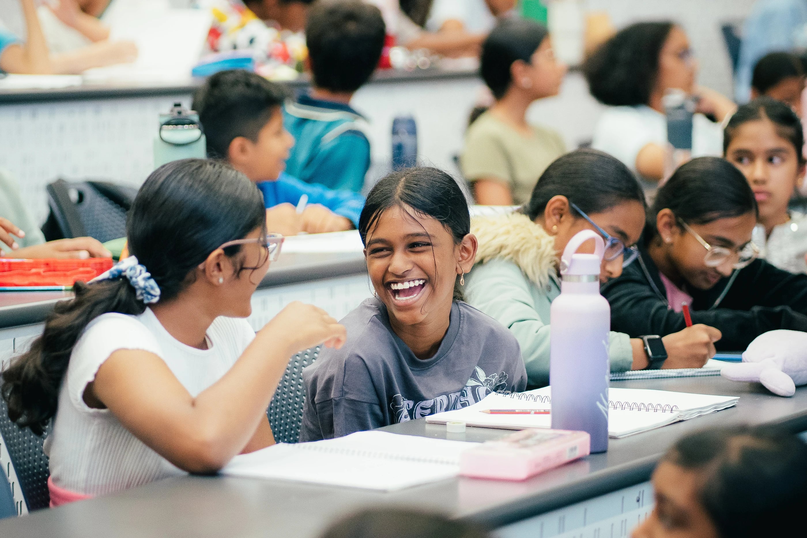 Two students laughing together during a masterclass