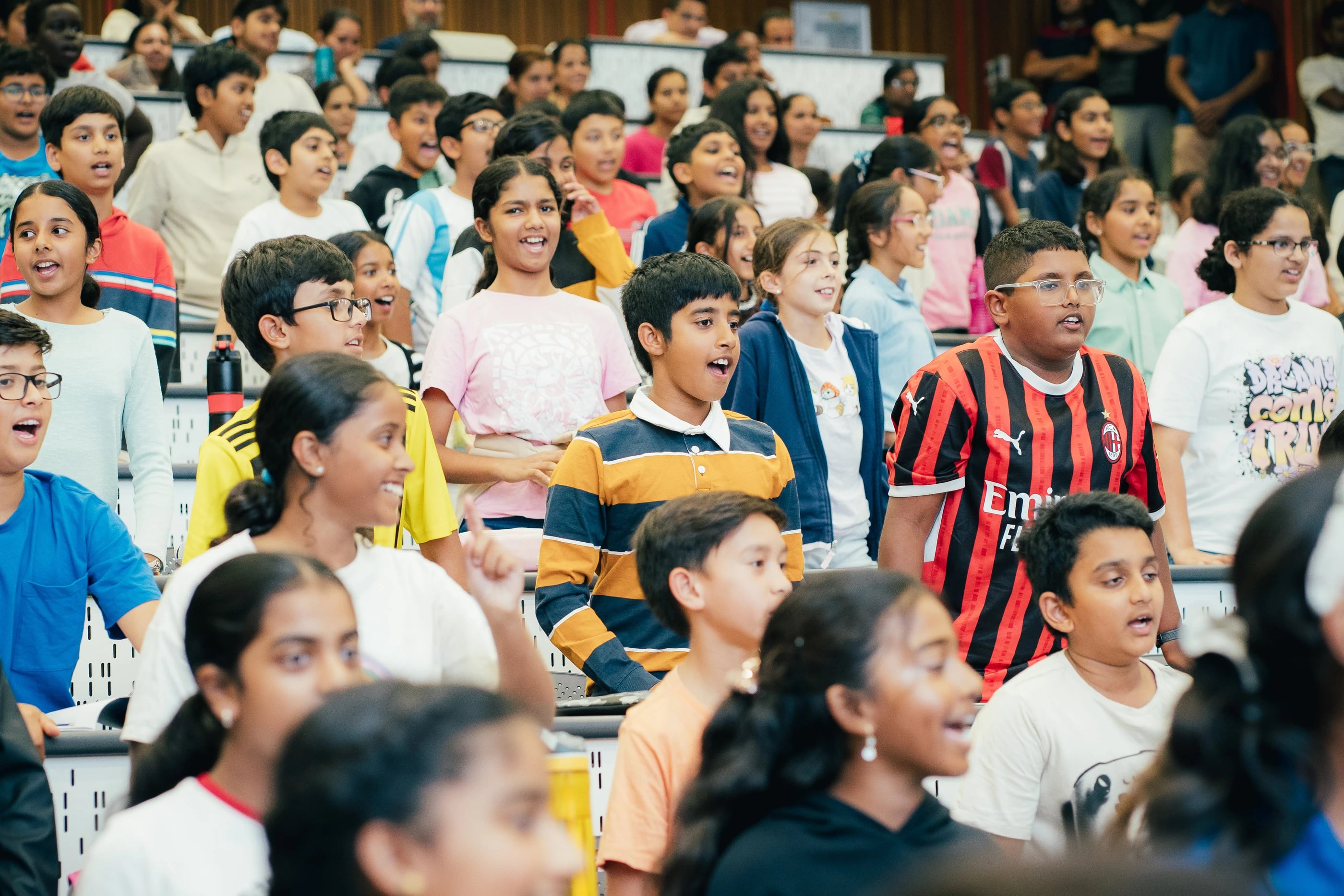 Students standing and participating in a group exercise