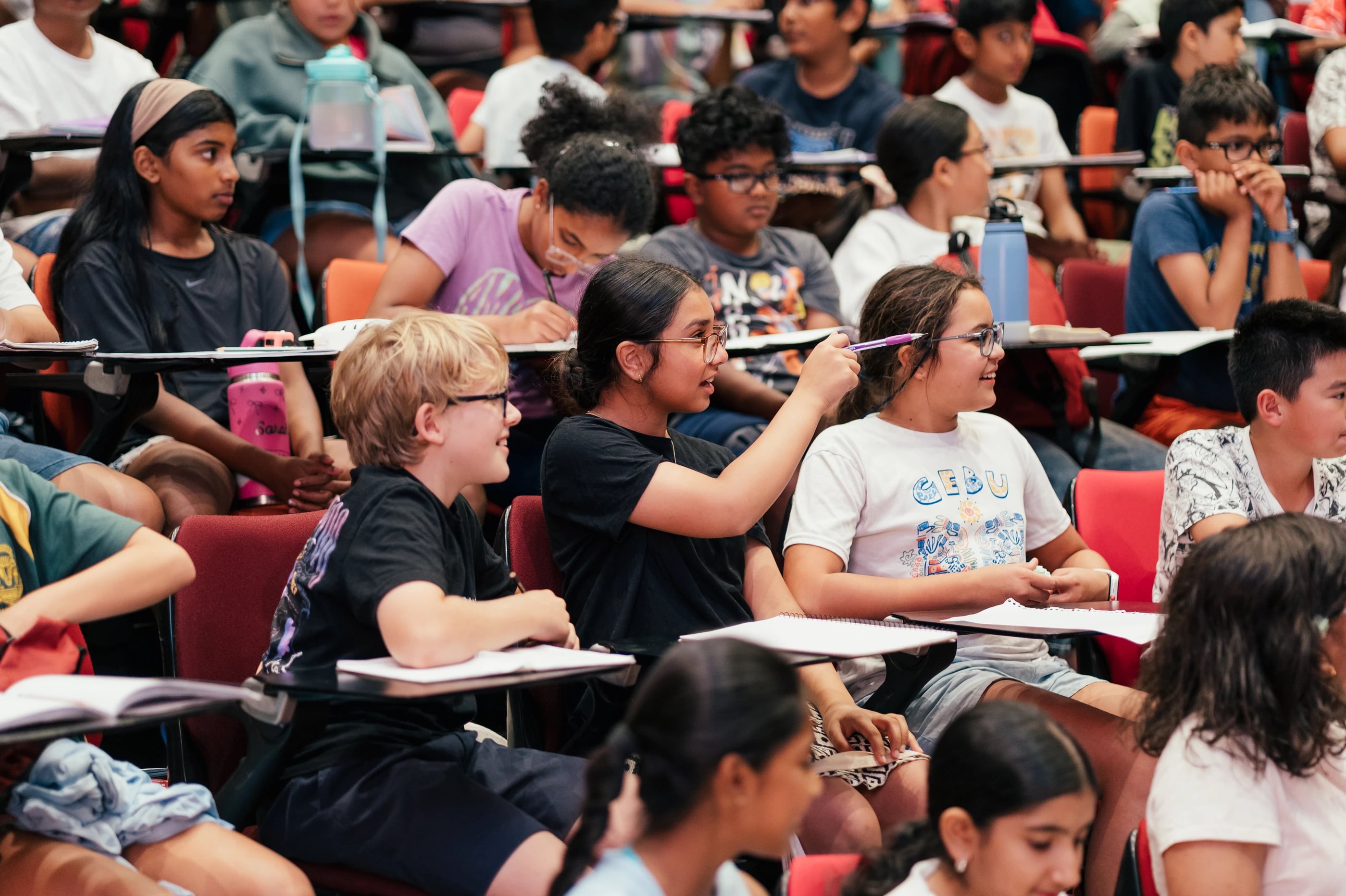Students participating in a discussion with their lesson notebooks open