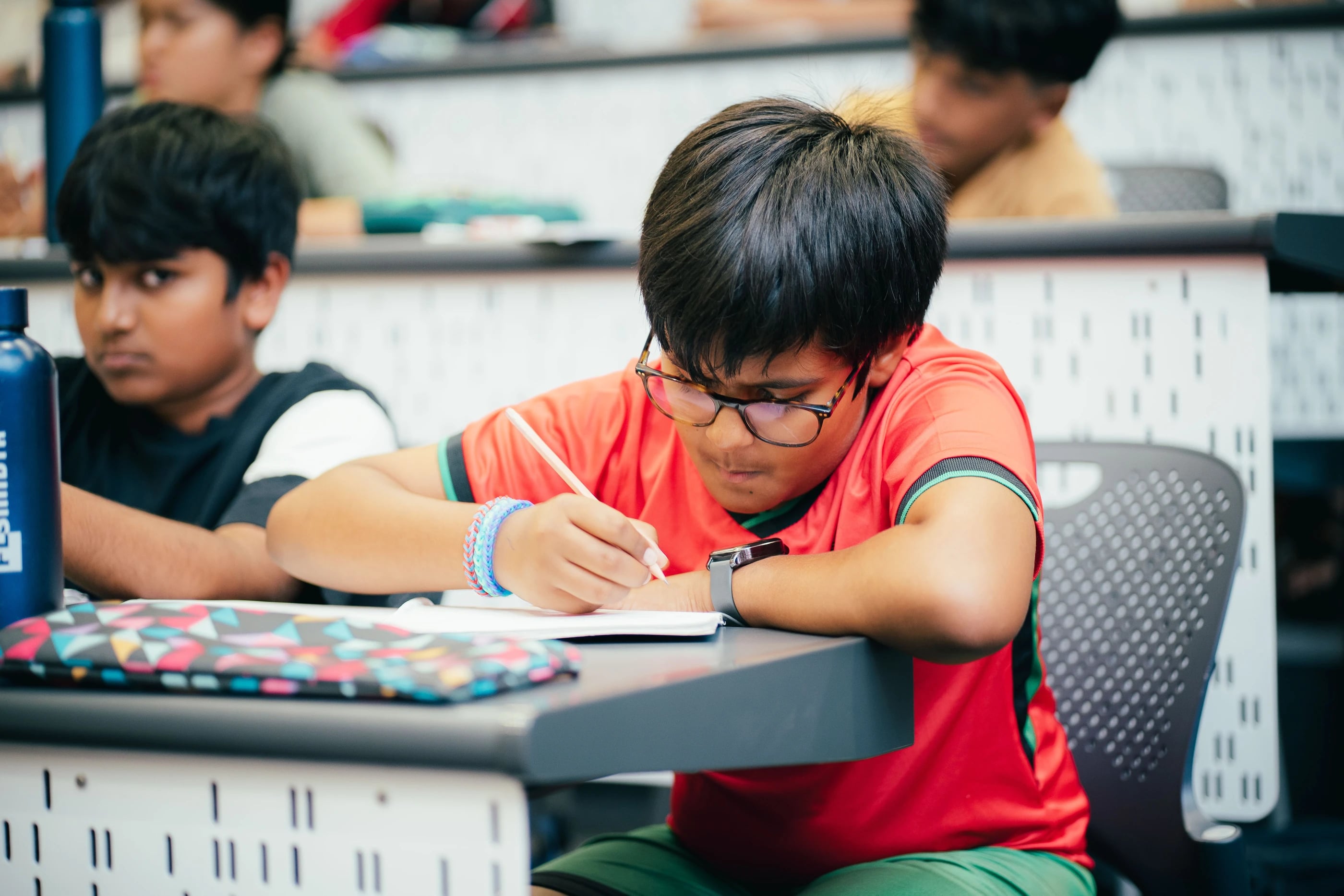 A student concentrating on a written task