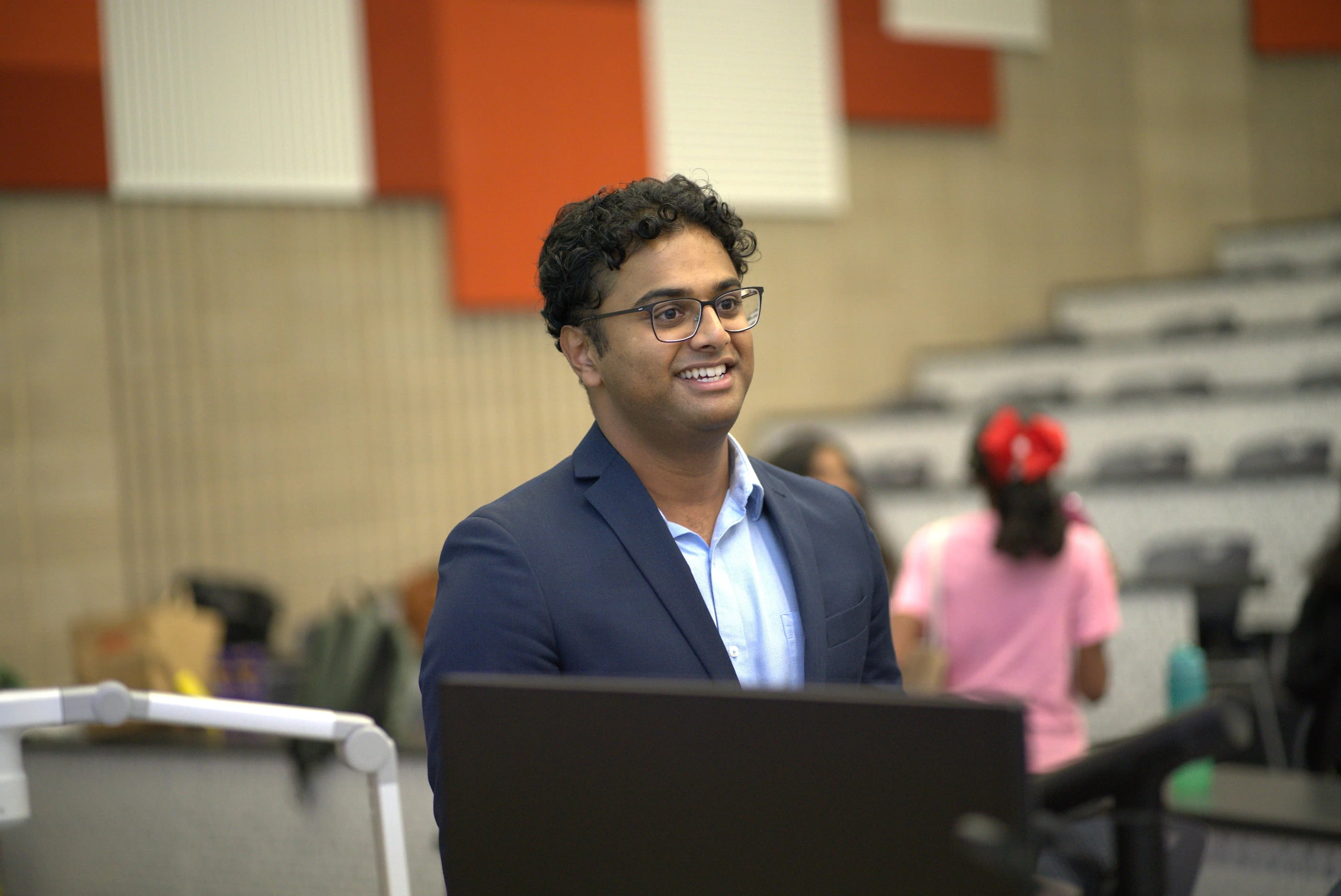 An educator speaking at the front of a Loyola masterclass