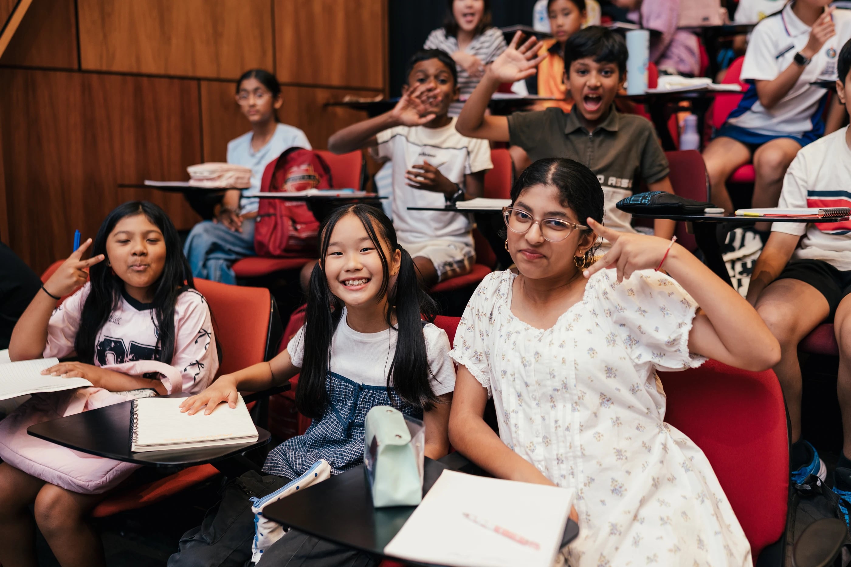 Students waving and smiling at a Loyola event